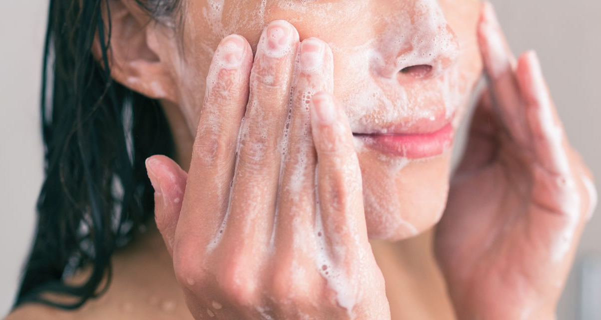 A woman washing her face. A woman washing her face.