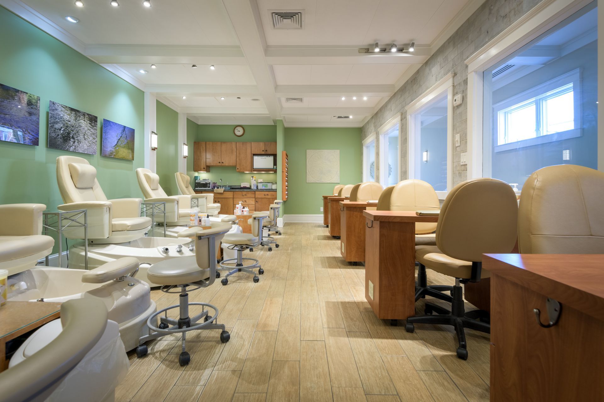 A nail salon with a lot of chairs and tables