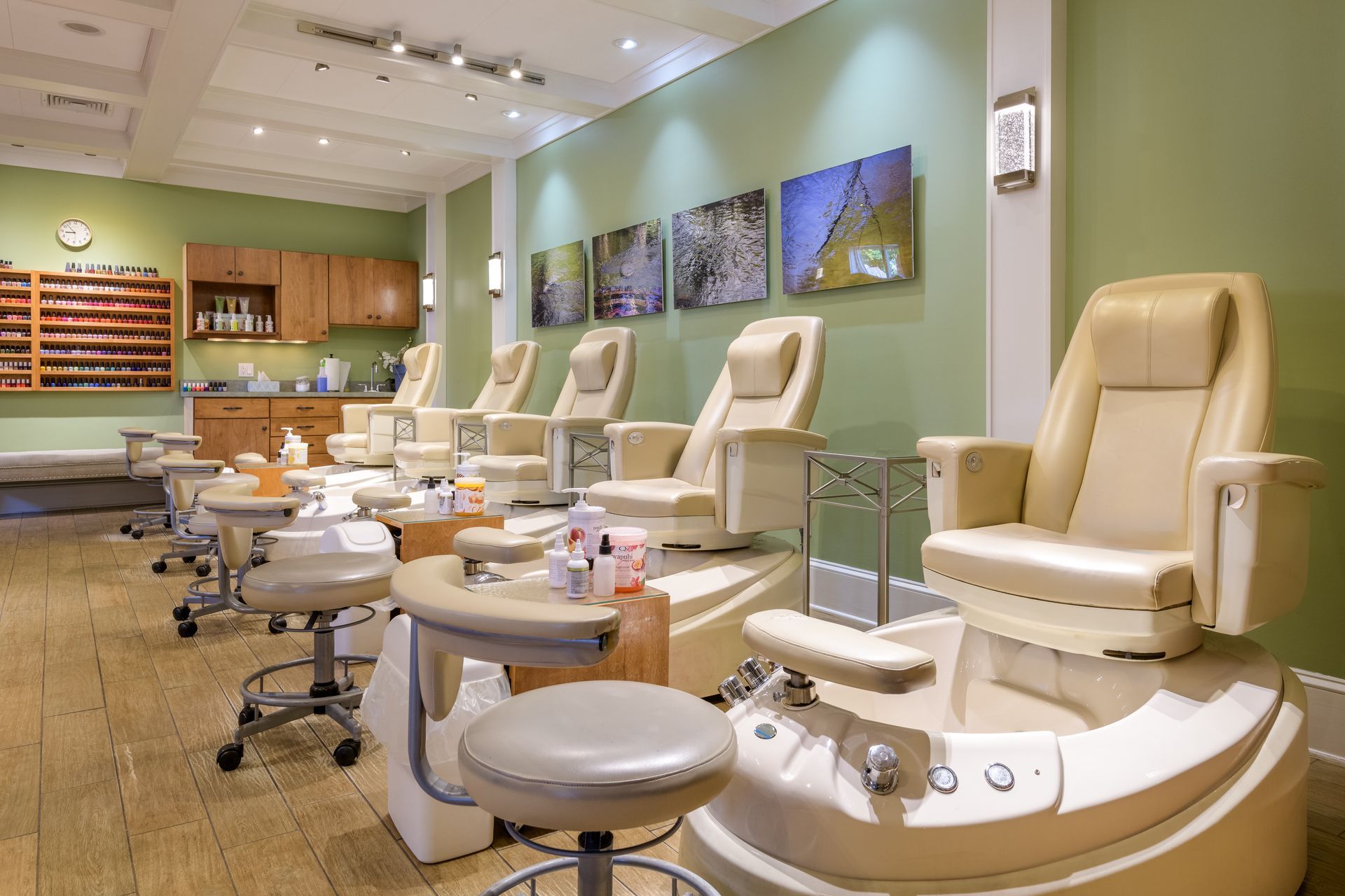 A nail salon with a lot of chairs and stools