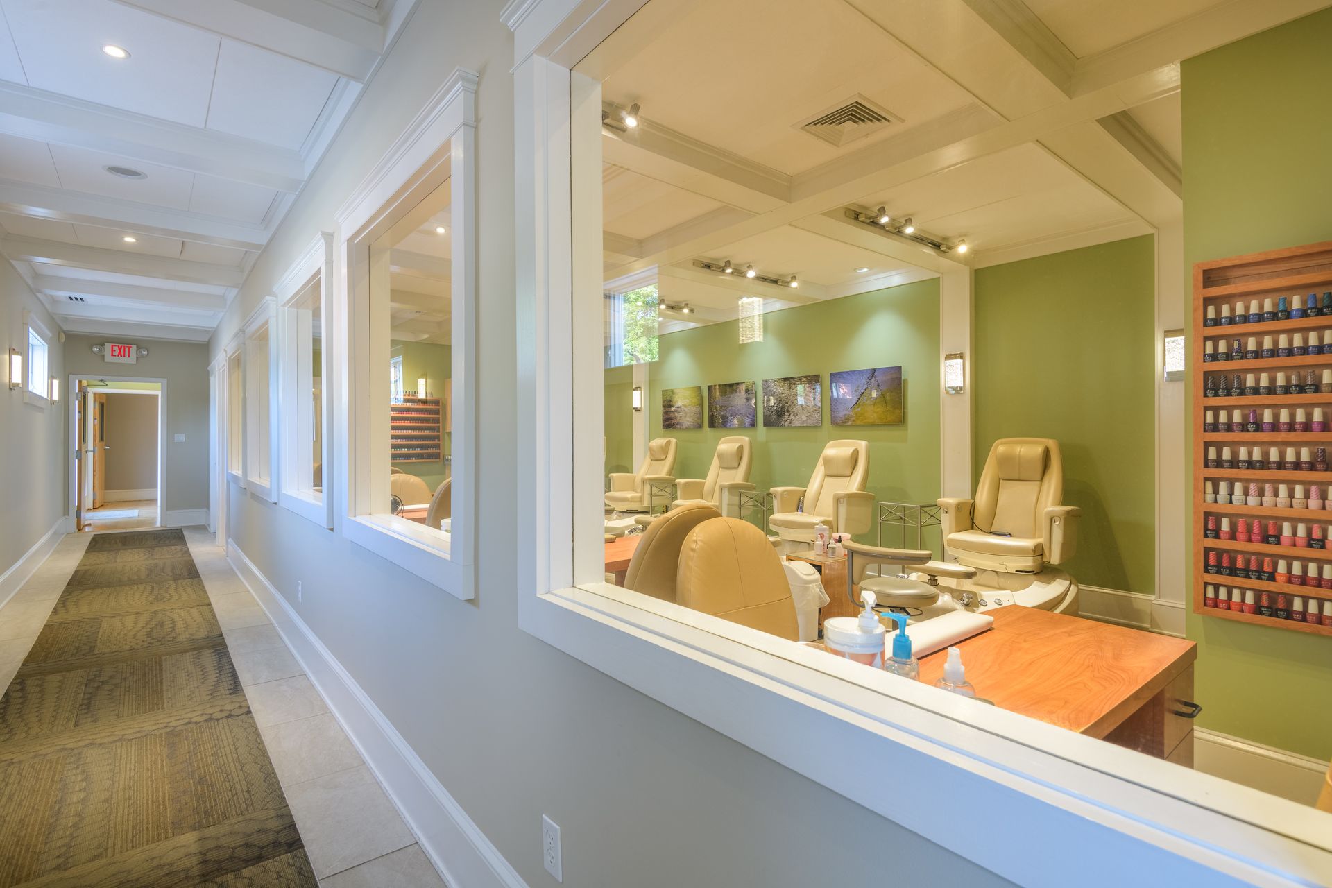 A view of a nail salon through a window.