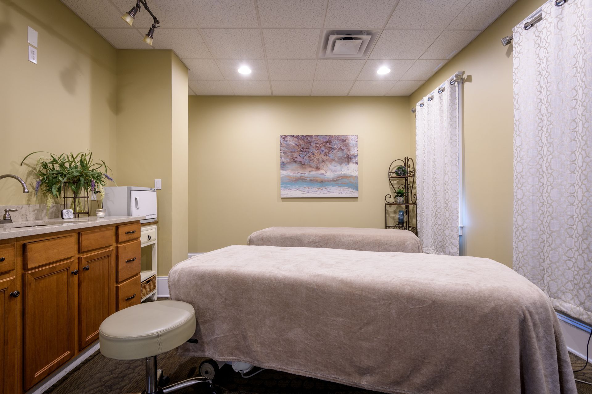 There are two massage tables in the room.