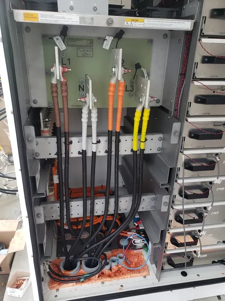 The inside of a electrical box with a lot of wires coming out of it.
