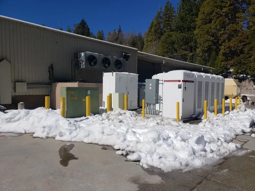 A building with a lot of snow on the ground in front of it