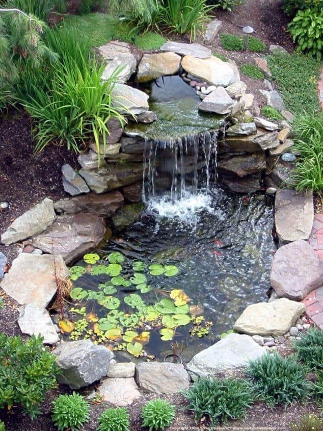 A small pond with a waterfall in the middle of it