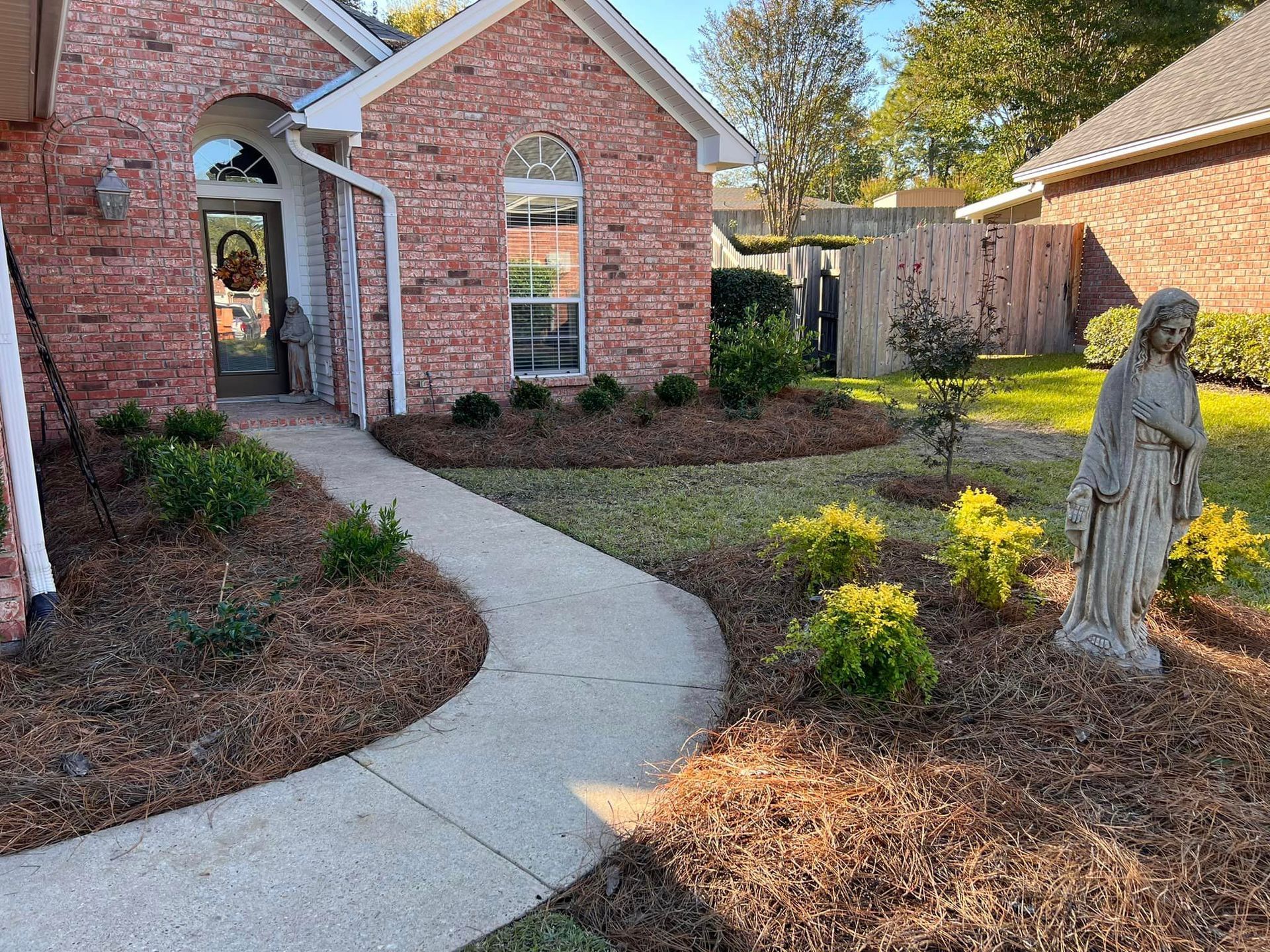Home with Green Grass and Covered Porch, including Stately Gables and Columns.