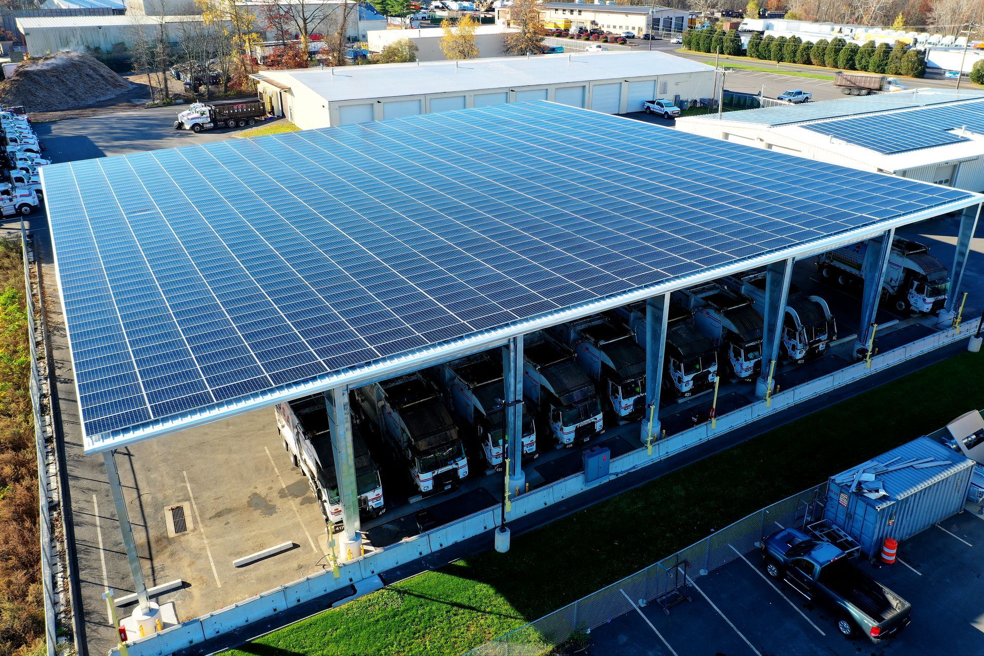 Large solar-panel canopy over a multi-level parking structure on a bright day