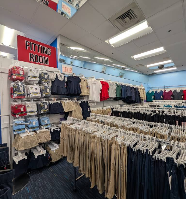 A clothing store called VIP Style in a mall, displaying clothes and mannequins.