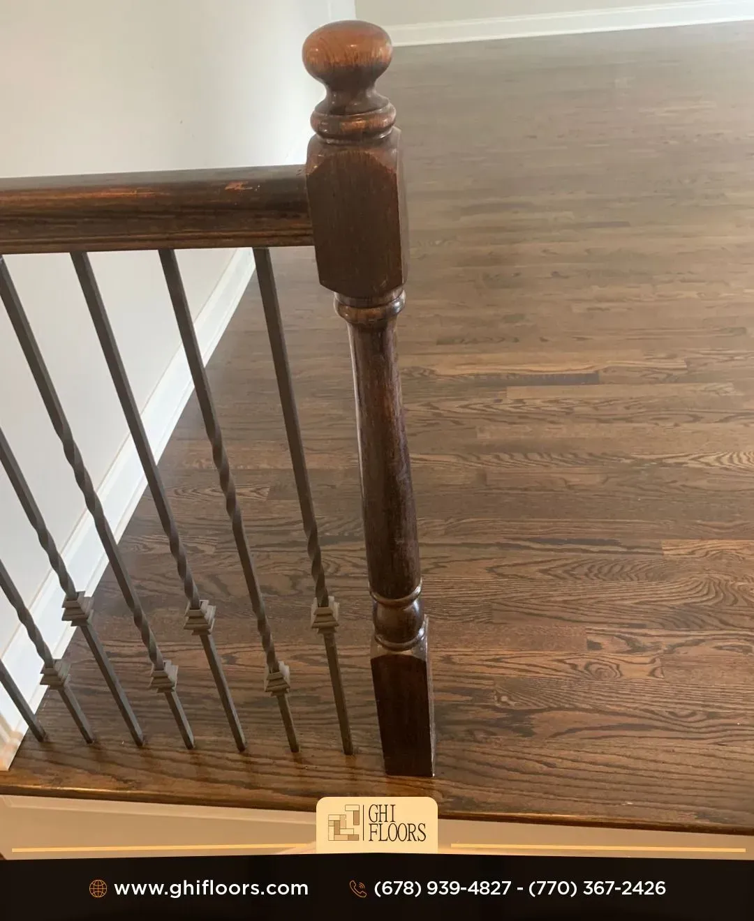 A close up of a wooden railing on a wooden floor.