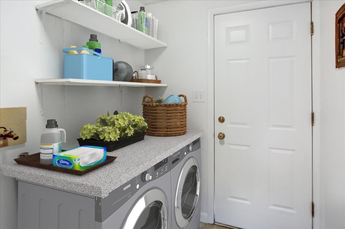 Laundry room with washing machine, white shelves, and a closed white door.