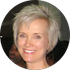 A woman with short blonde hair is smiling in a circle.