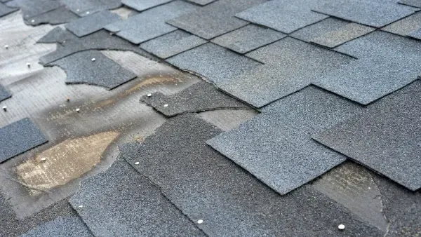 A close up of a roof with a lot of shingles on it.