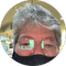 A man wearing glasses and a mask is in a circle.