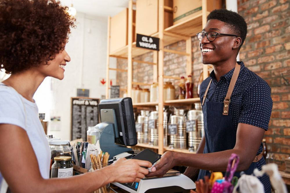 customer paying with credit card at bakery