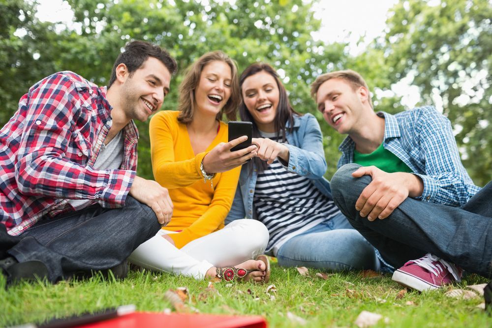 students looking at mobile device