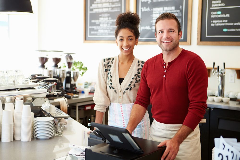 male and female staff in coffee shop
