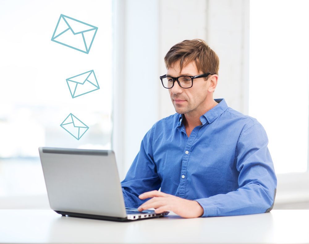 man looking at email on laptop