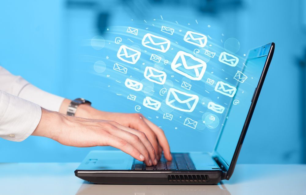 woman sending emails from computer