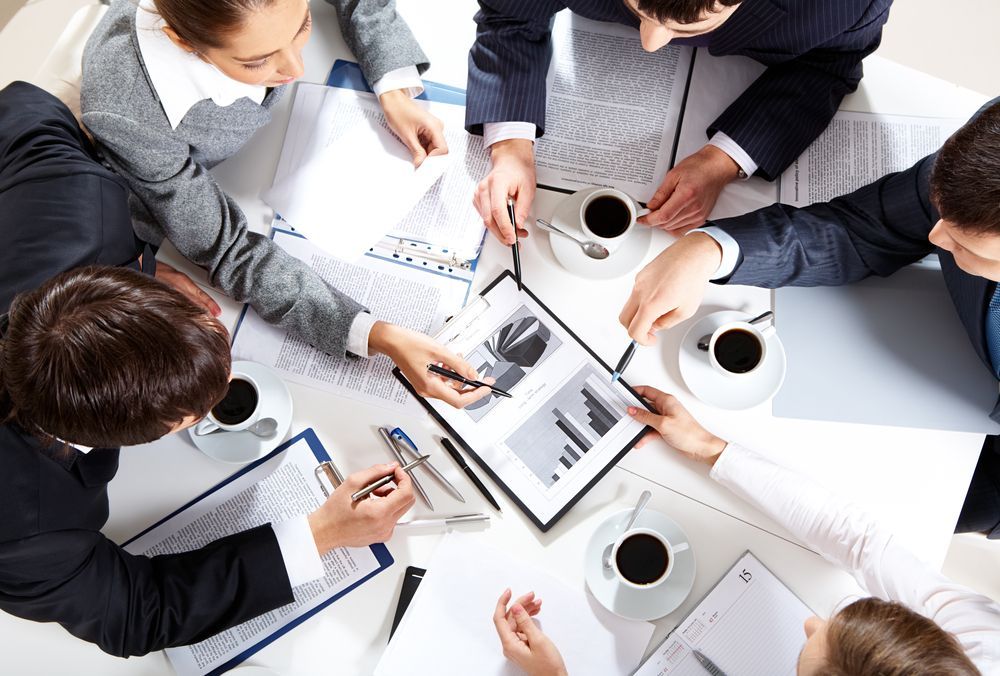 business team sitting at table discussing project