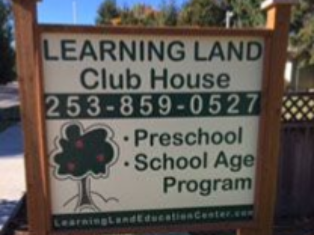 Sign for Learning Land Club House with phone number and program details.
