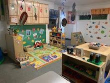 Playroom with wooden furniture, toys, and colorful decorations.