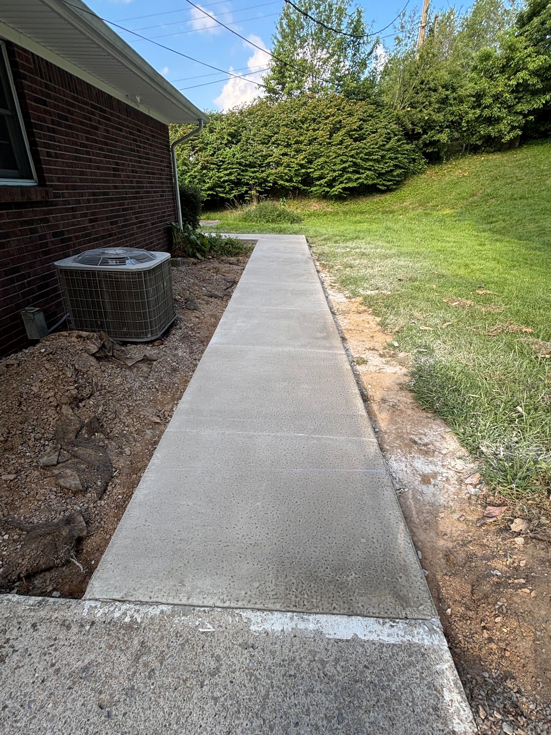 Concrete sidewalk installation in Boston, KY completed by Right At Home Construction LLC with broomed timeless finish.