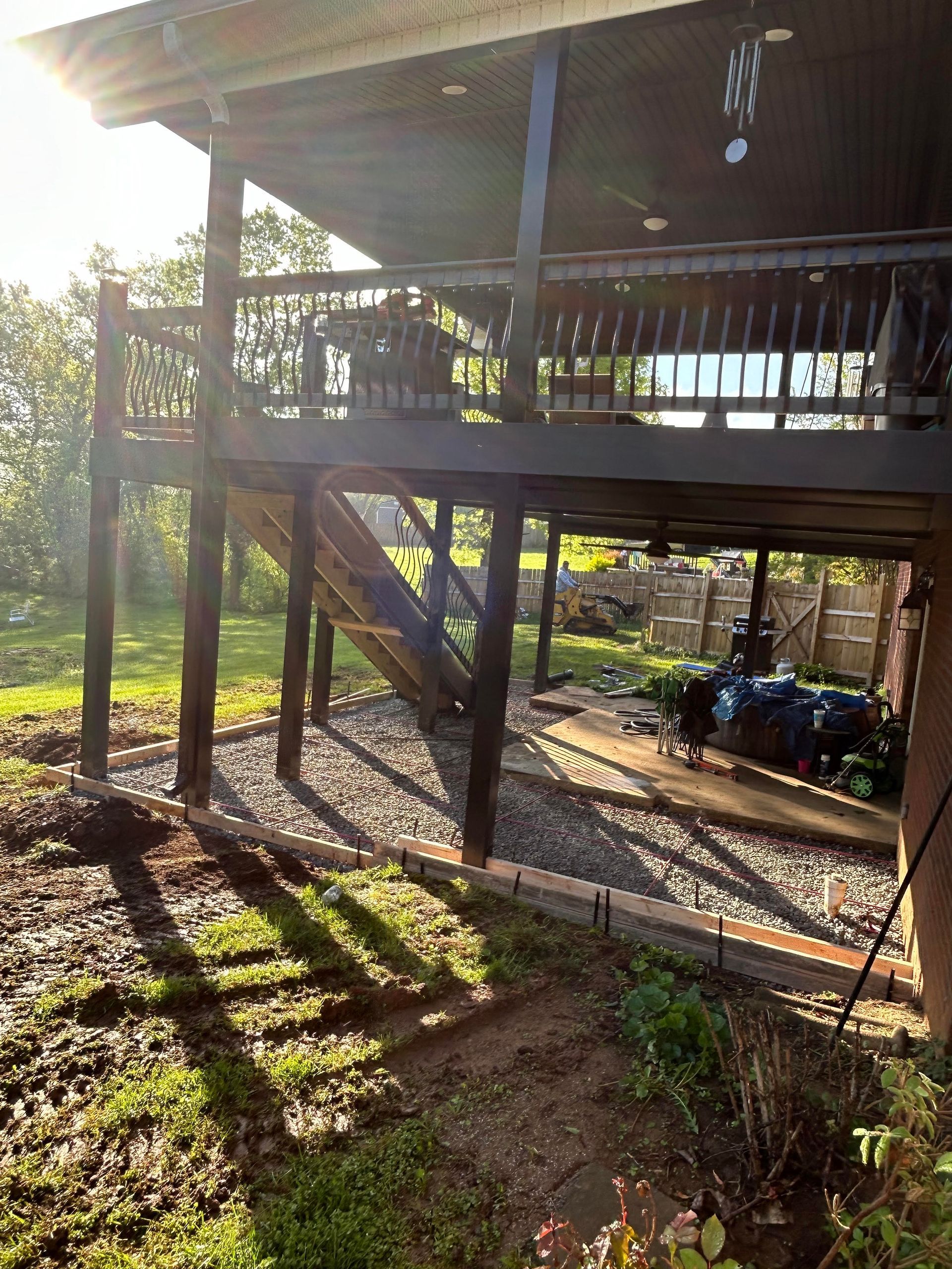 Custom concrete patio addition beneath a existing deck, creating a functional outdoor living space in Bardstown KY 