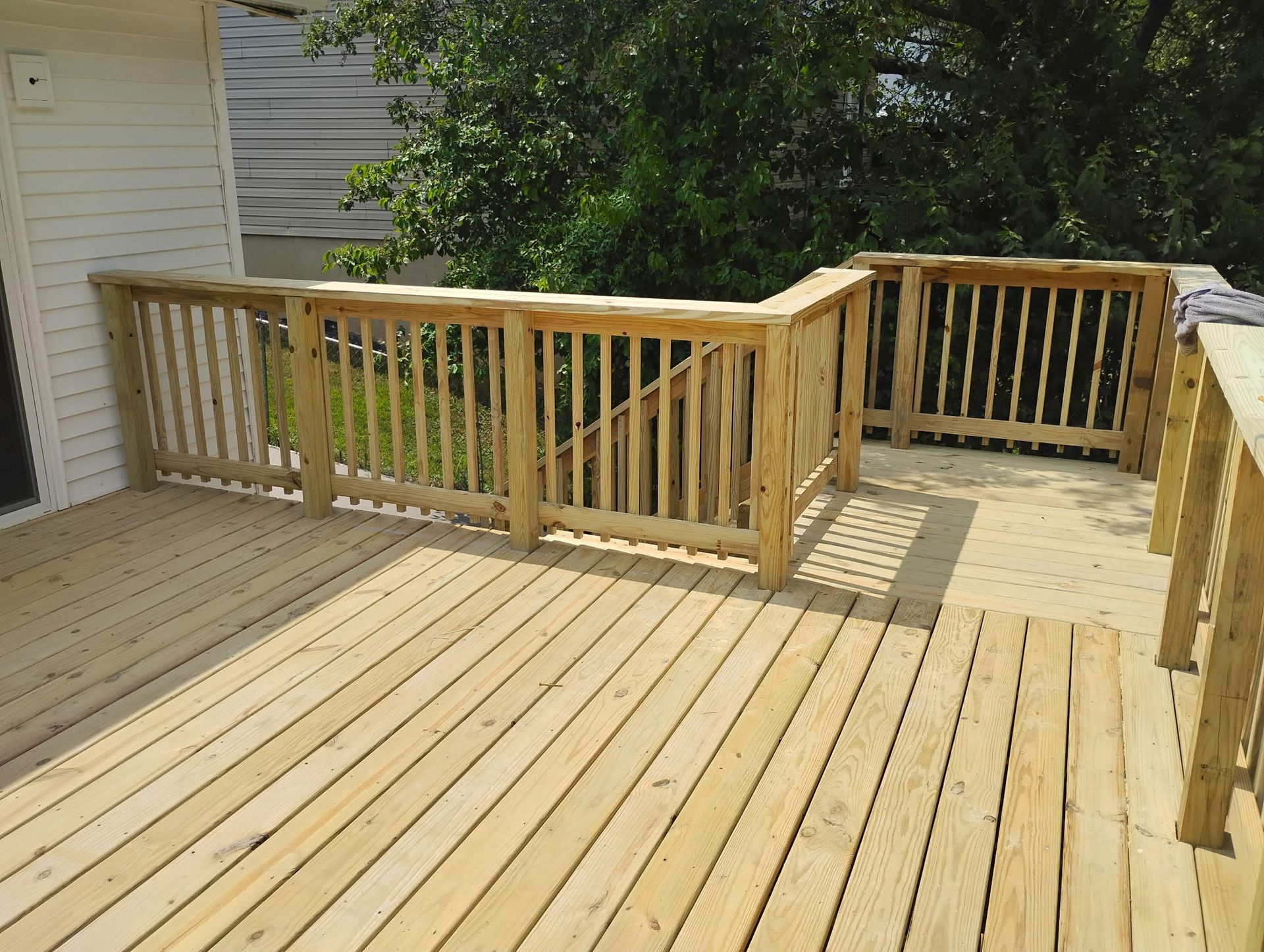 Custom pressure treated wood deck with wood spindles and steps 