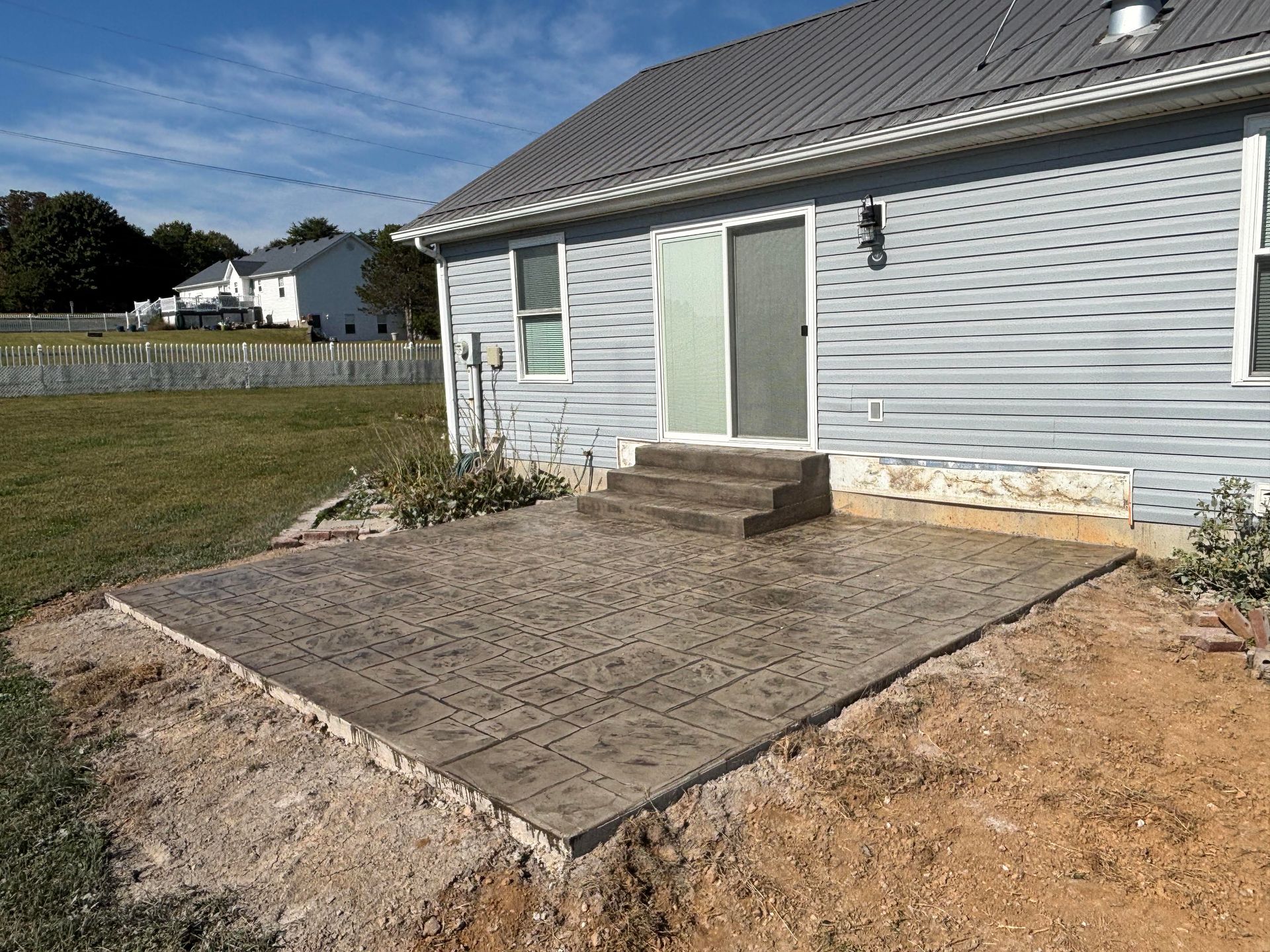 Stamped concrete  patio featuring paver stone, completed by Right At Home Construction LLC in Vine Grove KY