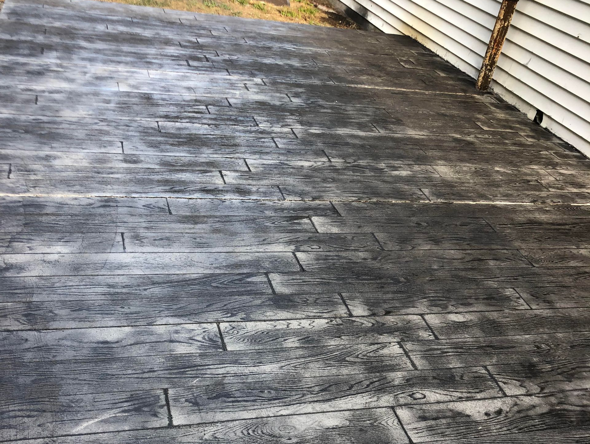 Custom stamped concrete patio featuring a wood plank pattern, creating a durable outdoor living area in Hodgenville KY