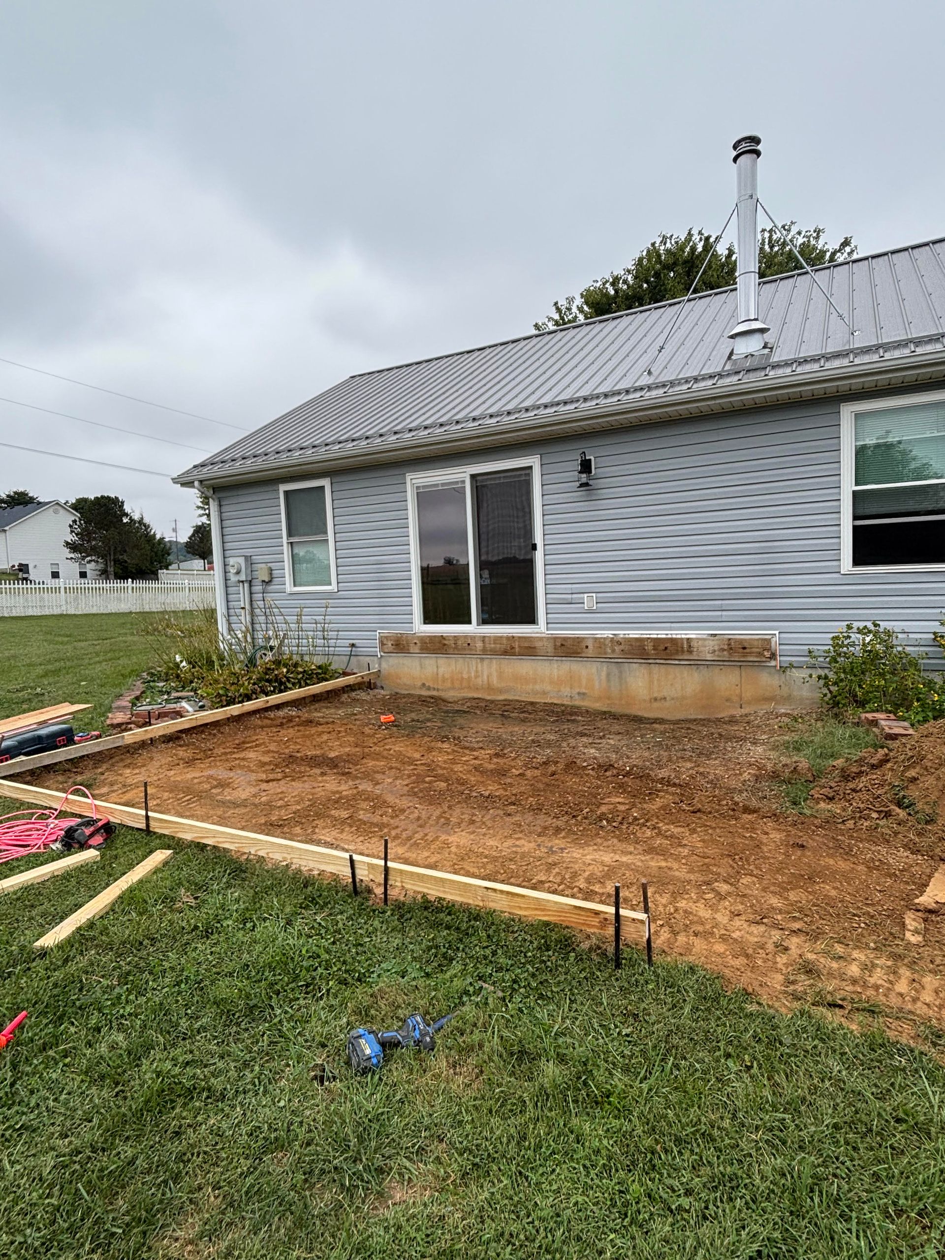 Stamped concrete  patio featuring paver stone, completed by Right At Home Construction LLC in Vine Grove KY