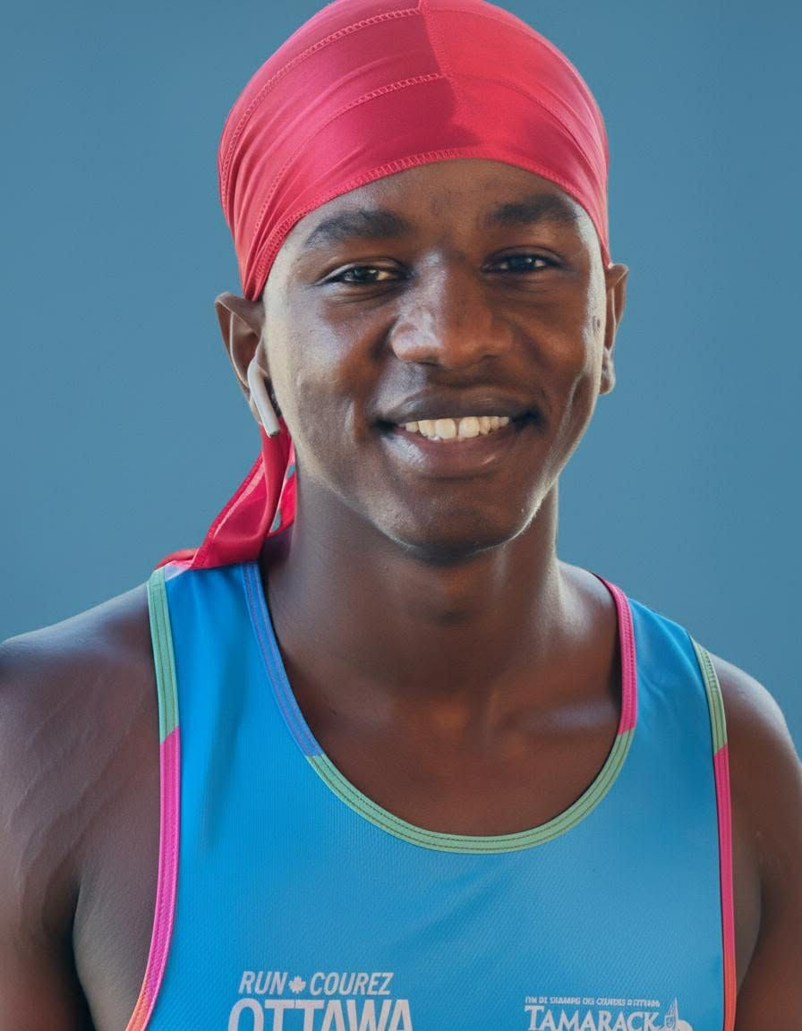 Smiling athlete wearing a red headscarf and a blue tank top, standing outdoors.