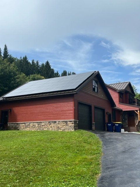 a red house with solar panels on the roof