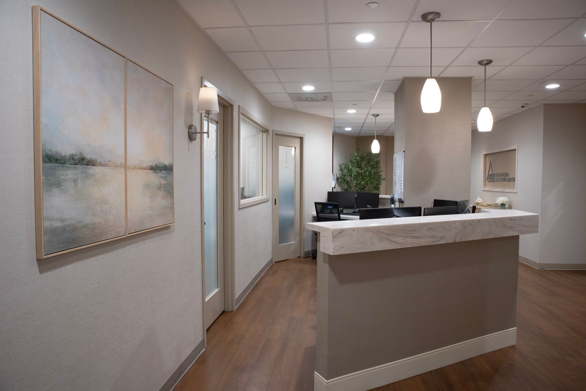 Dental operatory with chair, equipment, and window, with an orange accent wall.