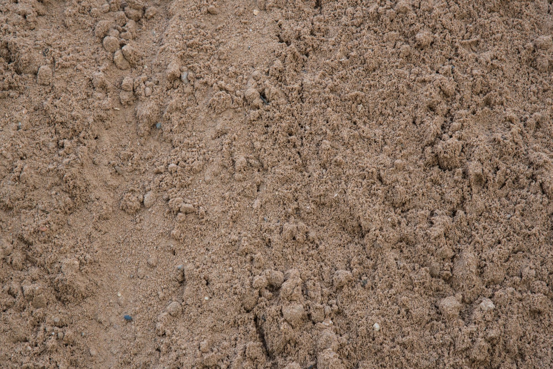A close up of a pile of sand on the ground.