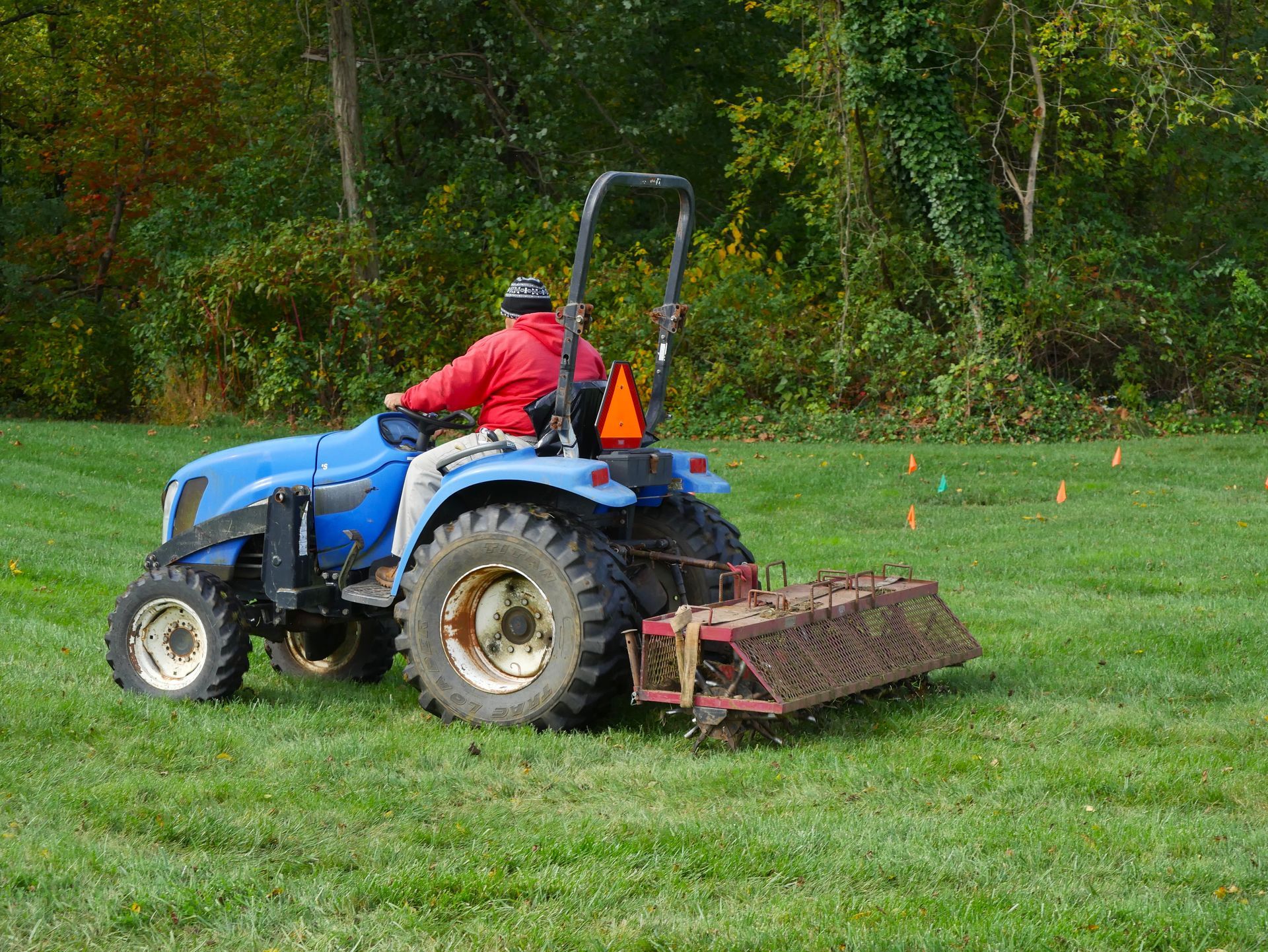 Contractor aerating a field