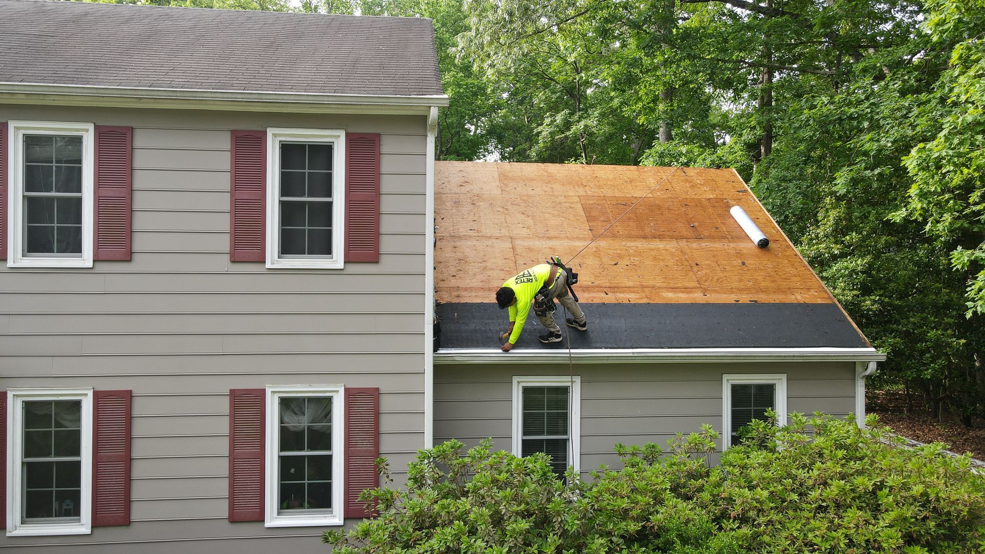 Image of a RETEX crew member installing drip edge during an asphalt shingle roof installation in North Chesterfield VA 23235.