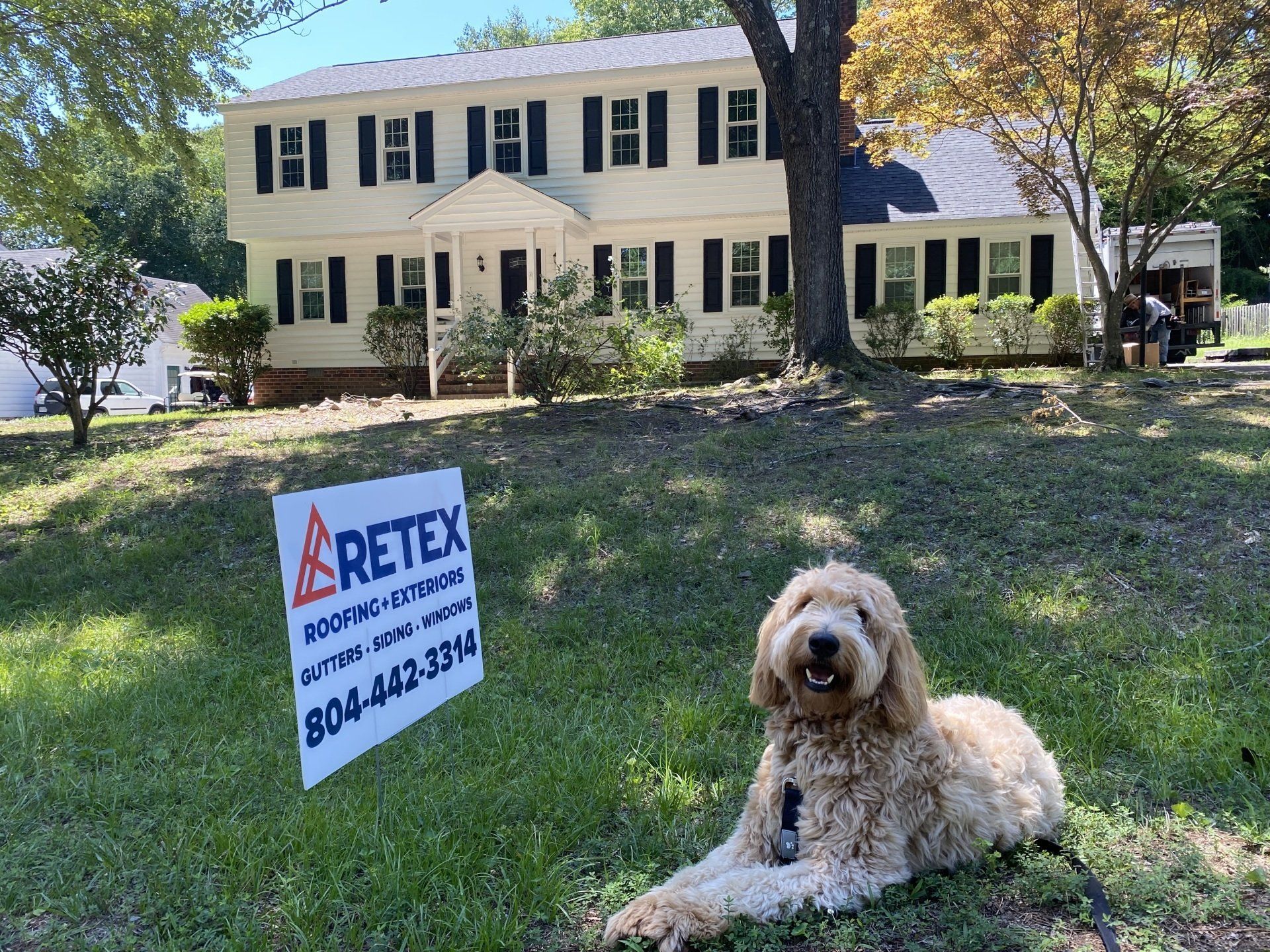 After photo of RETEX's Albus Lewis in front of a home that RETEX replaced the roof, siding, windows and gutters for in 2022.