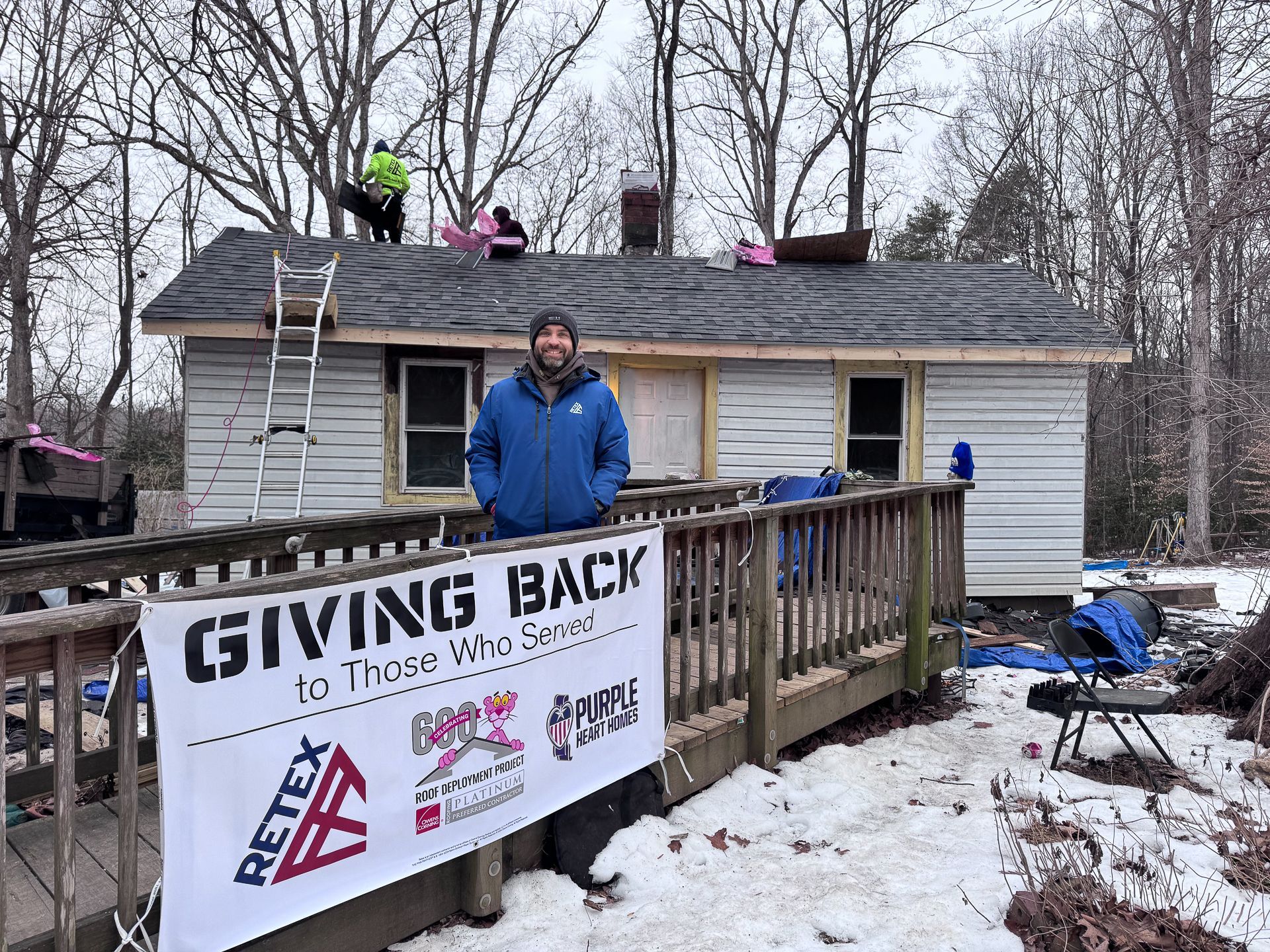 Photo of RETEX's Sean Purcell outside Spotsylvania Roof for a Veteran rproject during the installation in January 2025.