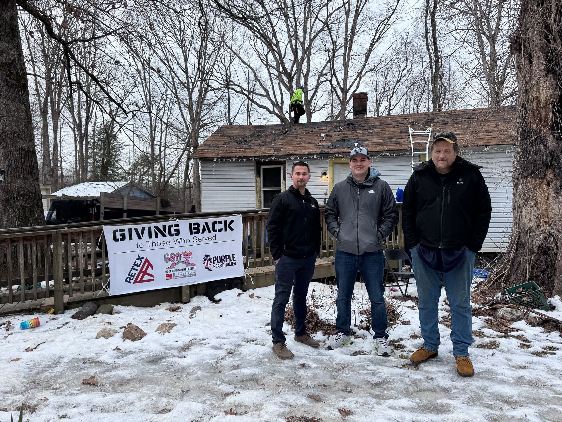 RETEX's Caleb Kammerling, Owens Corning's Trey Smith, and Matthew Carver in front of Spotsylvania Roof for a Veteran 2025.