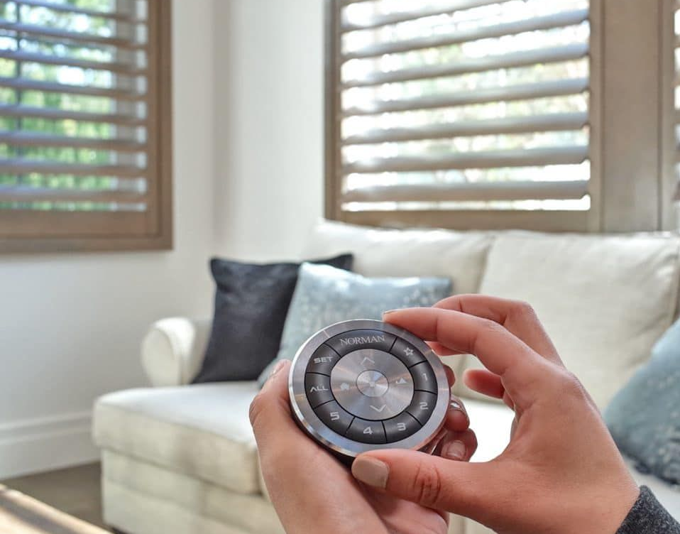 Norman® Woodlore® Motorized Shutters operated with a remote control.