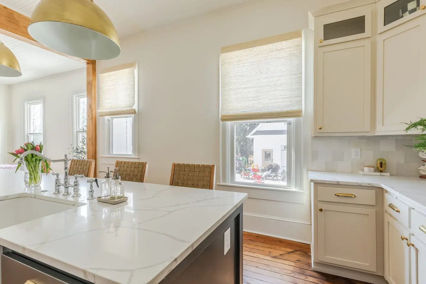 Woven Wood Shades in Kitchen with Warm White Cabinets and Gold fixtures.