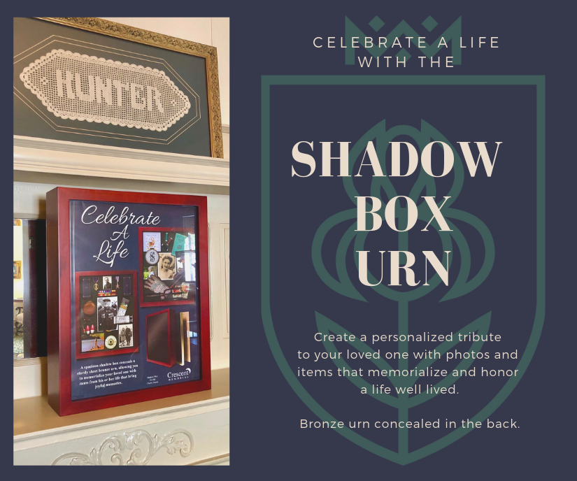 Shadow box urn memorial display in burgundy frame with assorted keepsakes and engraved sign