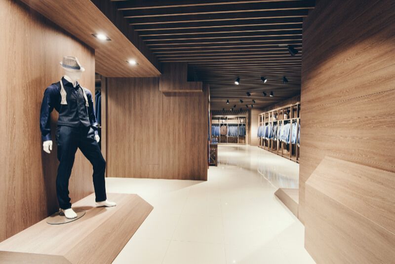 A mannequin is standing in a room with wooden walls.