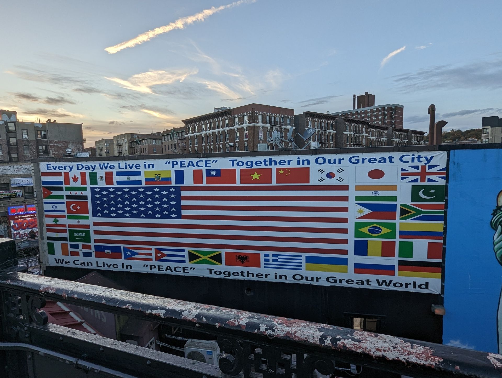 Mural with the American flag and flags of other nations, text: 