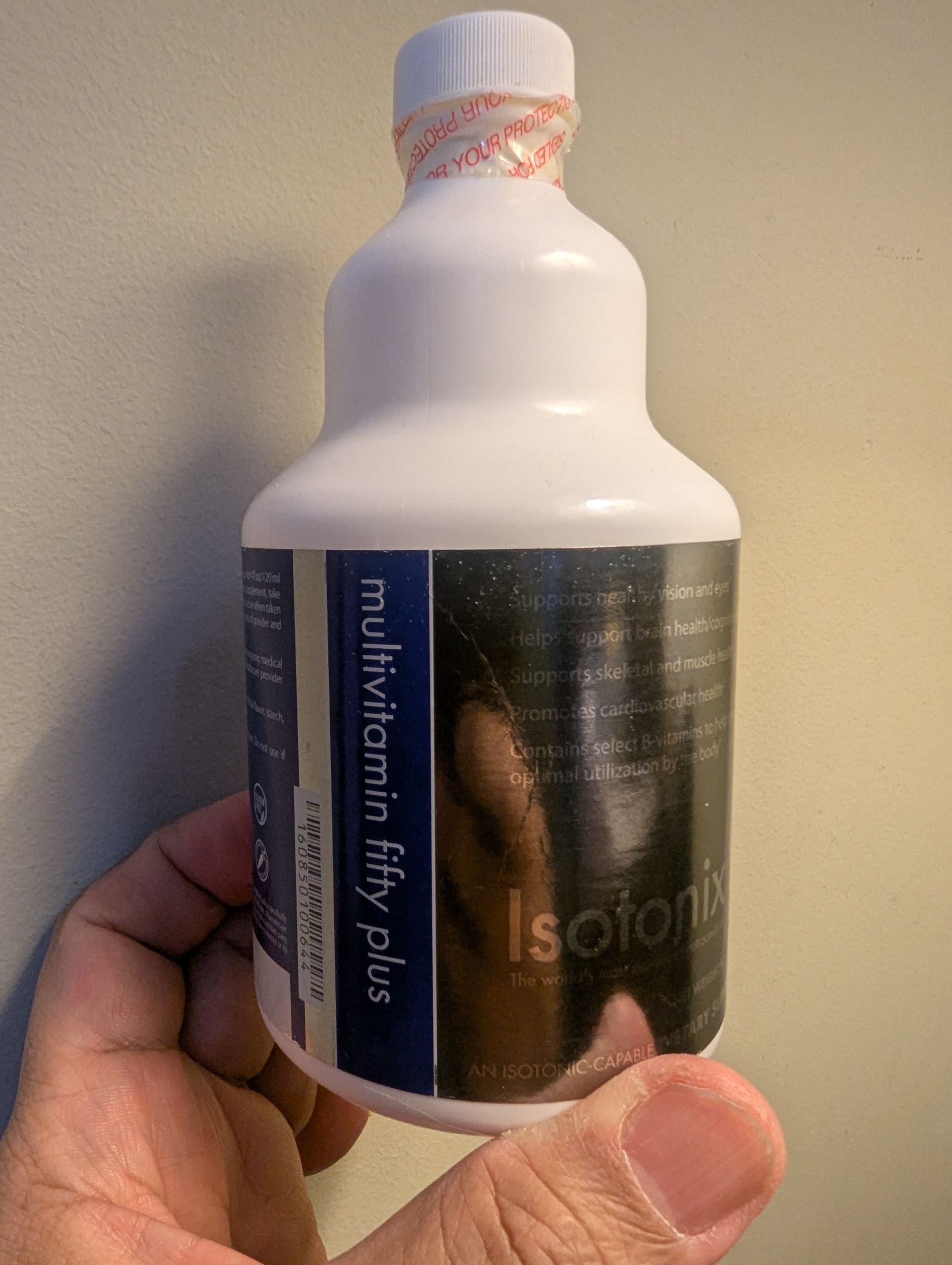 Person holding a white bottle of 