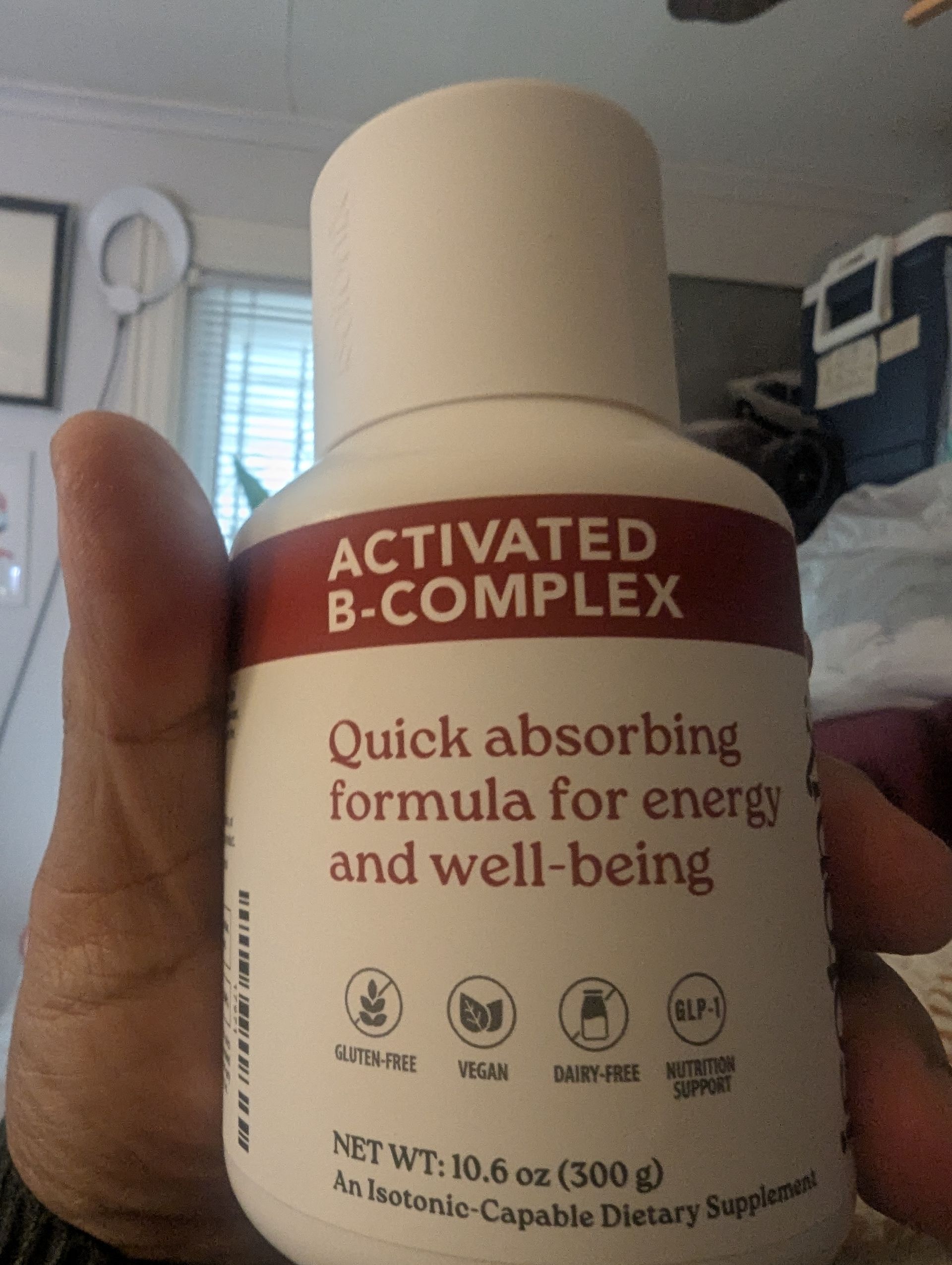 Hand holding a white bottle of