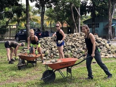 Missionaries unloading rocks at the mission house