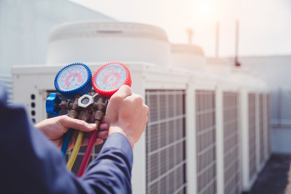 Licensed Technician is Installing a Commercial Air Conditioning Unit — PRO COOL NT In Virginia, NT