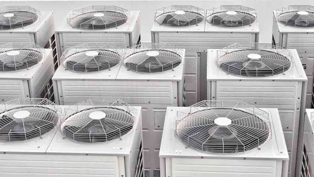 Row Of Air Conditioner Compressor On Roof High Building — PRO COOL NT In Port Hedland, WA