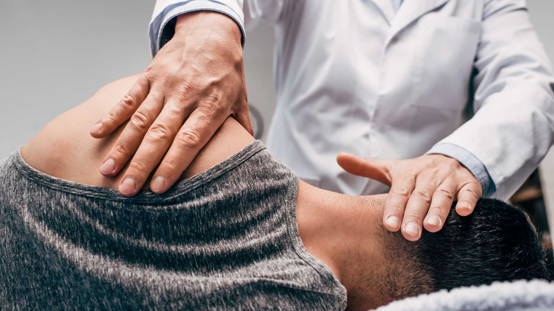 a man is getting a massage from a doctor .